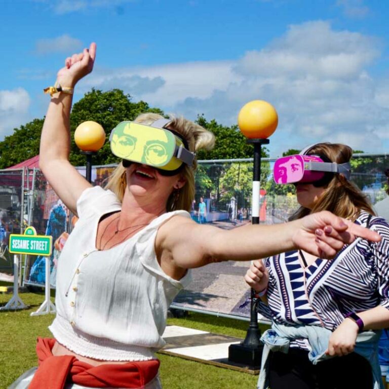 lady at festival wearing digital device with Beatles face